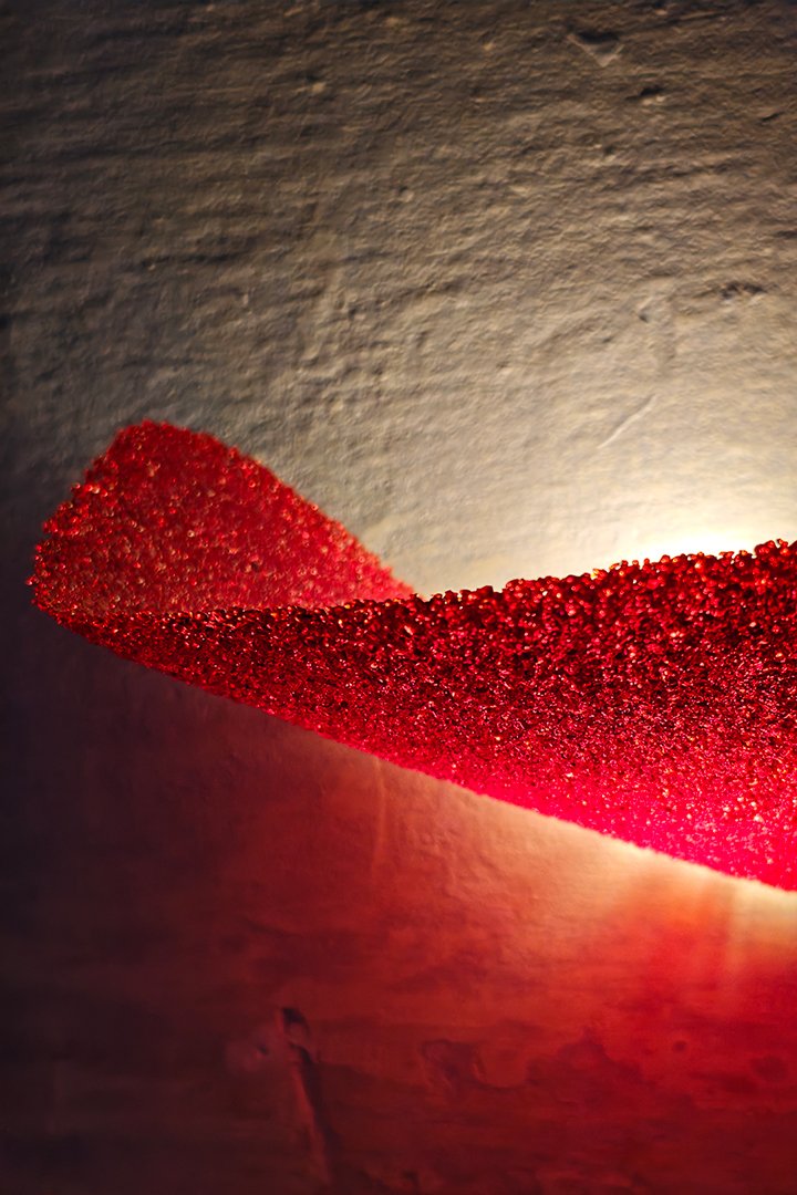 Red-glass-wall-sconce-close-up Sculptural red glass wall sconce lamp detail