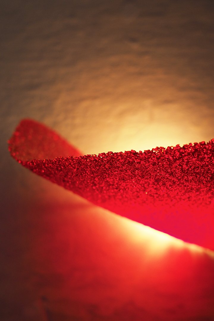 Sculptural red glass wall sconce lamp detail
